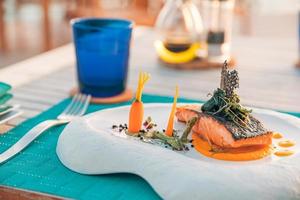 Luxury breakfast food fresh juice on wooden table, with beautiful tropical resort and sea view background, morning time summer holiday and romantic vacation concept, luxury travel and lifestyle mood photo