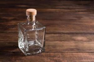 Transparent bottle with wooden cork photo