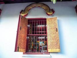 Ancient wooden window Thai art pattern in northern Thailand. photo