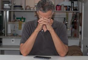 Mature Man at Home bored thinking about what to do photo