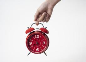 Red alarm clock on white background. Alarm clock photo