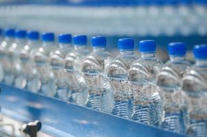 Plastic water bottles on the conveyor photo