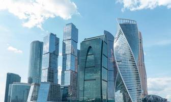 High rise buildings of the business center of Moscow. District Moscow-city against the day sky with clouds photo