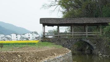 The old arched stone bridge made many years ago in the countryside of the China photo