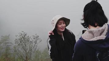 Couples of Asian tourists blogger using action camera to record journey and talking about tourist attractions in the mountains. Outdoor travel and Nature theme. video