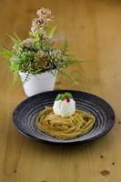 Delicious little cake and chocolate on plate with flower background on table photo