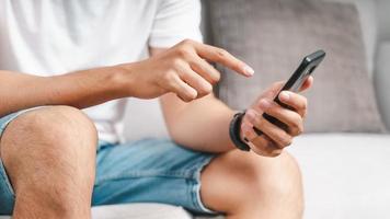 Closeup of happy man using a smartphone, searching, browsing, social media, message, email, play game, internet digital marketing, online shopping. photo