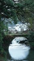 The old arched stone bridge made many years ago in the countryside of the China photo