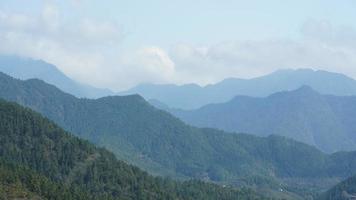 The beautiful mountains view with the green forest and flowers field in the countryside of the southern China photo