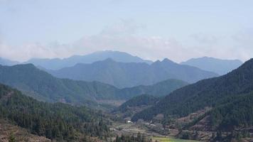 The beautiful mountains view with the green forest and flowers field in the countryside of the southern China photo
