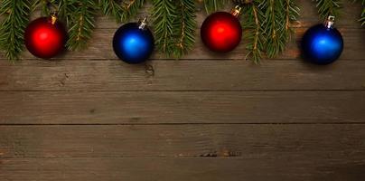 Two red christmas balls,two blue balls and fir tree branches. photo