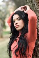 Woman wearing orange dress in an urban park photo