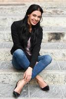 Hispanic young woman wearing casual clothes in urban background photo