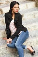 Hispanic young woman wearing casual clothes in urban background photo
