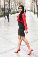 Hispanic stewardess in urban background photo