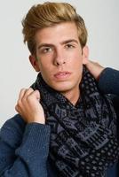 Portrait of good looking blonde man wearing a scarf photo
