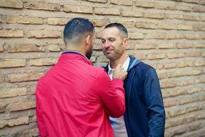 Gay couple in a romantic moment on the street. photo