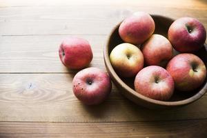 Ripe apples on a wooden background photo