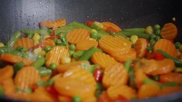 Season the vegetables cooked in a pan with salt. video
