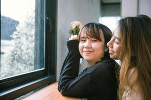 LGBT lesbian women couple moments happiness. Lesbian women couple together outdoors concept. Lesbian couple embraced together relation fall in love. Two asian women having fun together at rooftop.
