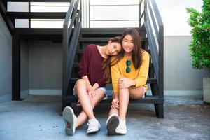 LGBT lesbian women couple moments happiness. Lesbian women couple together outdoors concept. Lesbian couple embraced together relation fall in love. Two asian women having fun together at rooftop. photo