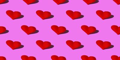 Red heart with a hard shadow on a pink background. Seamless patterns. Celebrating Valentine's Day copy space. Banner photo