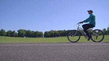 Guy cycling in park.