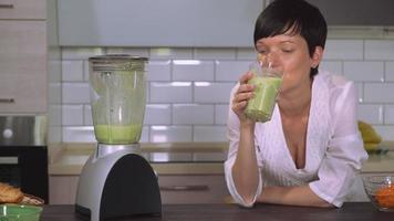 Portrait girl enjoy green drink. video