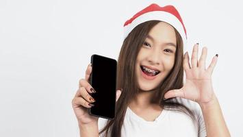 Asian woman with smartphone in hand which posing like selfie or video call photo