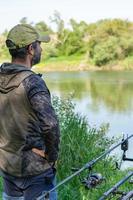 adult man with beard doing a fishing session on the ebro river photo