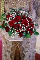Wedding bouquet of flowers in brides' hands photo