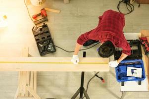 Asian young man carpenter work for customers meticulously He is a young man, a successful entrepreneur and very skilled. photo