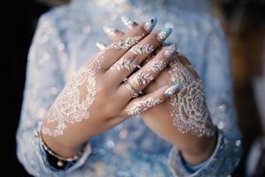 Bride henna carved beautiful and unique at bride's hand photo