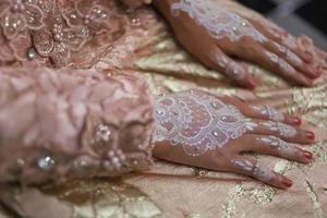 Bride henna carved beautiful and unique at bride's hand photo