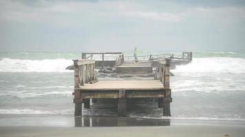 Italy coast Tyrrhenian sea in stormy weather - Waves fall on the old wooden pier video