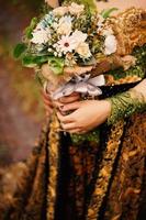 Wedding bouquet of flowers in brides' hands photo