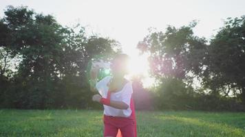 Front view of boy playing sword in the park, holding a sword in his hand with sunlight background, going out to the park on the weekend and cover to be a hero. Hero costume concept video