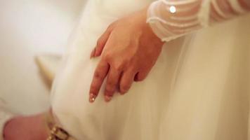 the body part of the bride's right hand moves in her left hand video