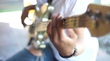 Part of a man's hand playing a musical instrument video