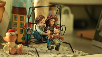 couple in love romantic date on a swing close-up figurines boy and girl video