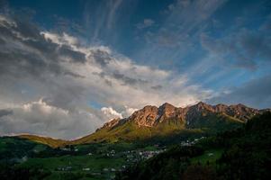 Mountain in the clouds after the storm with rainbow photo