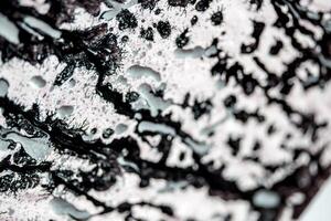 abstract beautiful liquid dark black marble fluid acrylic paint vibrant texture on white. photo