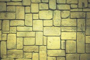 abstract yellow stone wall realistic texture ornament building rock on nature pattern bright. photo