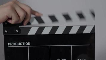 Clapper board. Close up hand and film making clapperboard isolated on background video