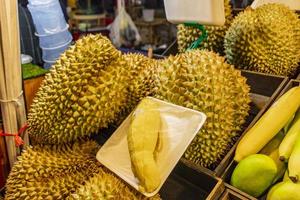Smelly fresh durian fruit Thai night market street food, Bangkok. photo