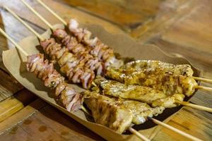 Chicken skewers Thai night market street food in Bangkok, Thailand. photo