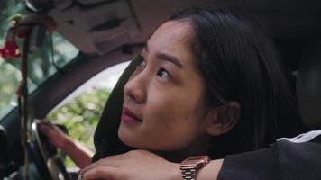 Asian young women travel relax in the holiday with her boyfriend on forest. Beautiful Asian woman feeling refreshed and enjoying nature through the car window. Transportation and weekend travel. video