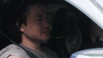 Handsome man driving car on dirt road in the forest. Young man traveler Driving car and looking at the nature around him. Adventure vacations in nature. video