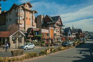Gramado, Brazil - July 21, 2019. Buildings with shops and people on causeway at Borges de Medeiros Avenue, the main street of Gramado. A cute european-influenced town highly sought after by tourists.