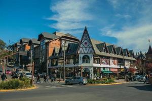 Gramado, Brazil - July 21, 2019. Buildings with shops and people on causeway at Borges de Medeiros Avenue, the main street of Gramado. A cute european-influenced town highly sought after by tourists.